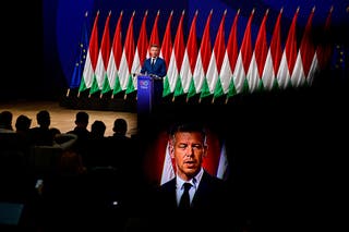 Peter Magyar, leader of the opposition Tisza Party, is seen throught a camera's viewfinder while speaking during a press conference
